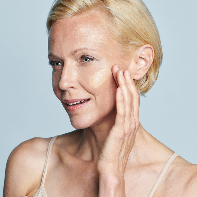 Model with swatch of Even Up® Clinical Pigment Perfector® SPF 50 || all